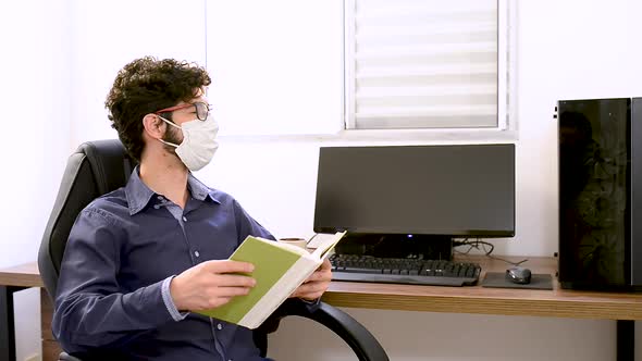 Green book reading Face mask on at Office alt