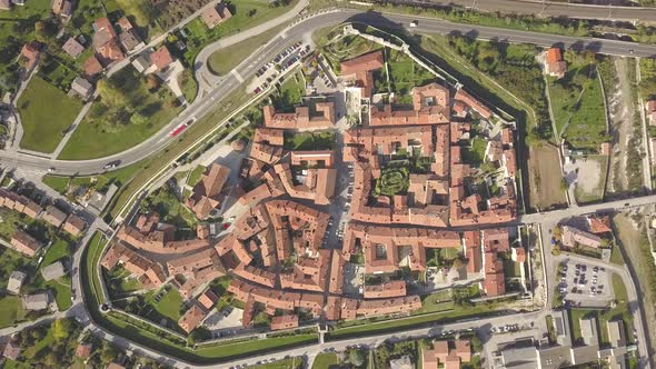 Top down aerial view of a small historic town Venzone in Northern Italy with red tiled roofs alt