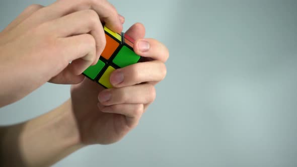 Solving Rubik's cube with hands in studio shot with white background 4k alt