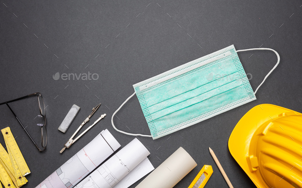 Engineer blueprints, equipment and protective mask on black background - Stock Photo - Images