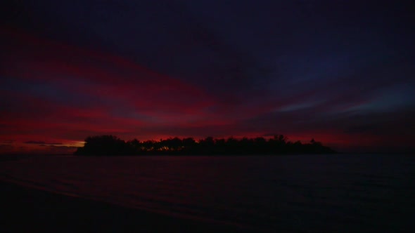 View of a scenic tropical island in Fiji at sunset. alt