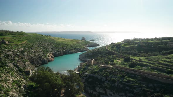 AERIAL: Small Isolated Magrr Ix-Xini Bay on Sunny Day in Gozo Island