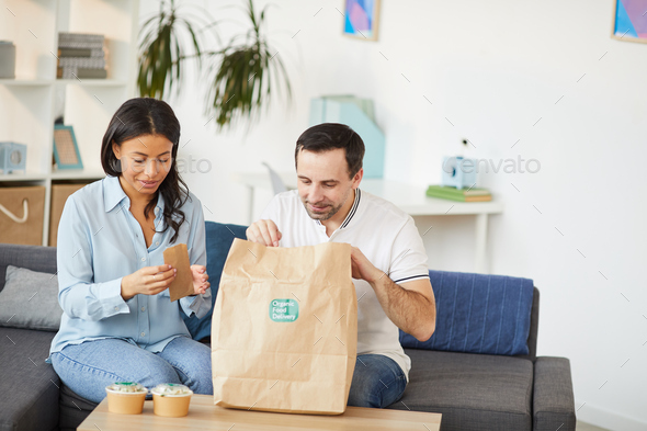 Office Workers Unpacking Takeout Lunch - Stock Photo - Images