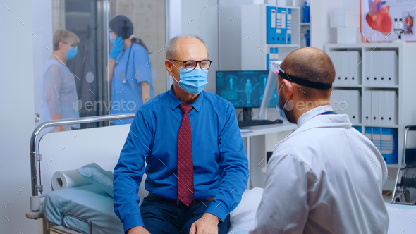 Senior patient wearing mask at doctor appointment - Stock Photo - Images