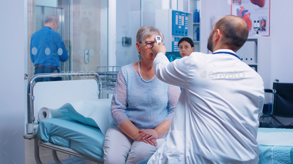 Measuring old senior woman temperature - Stock Photo - Images
