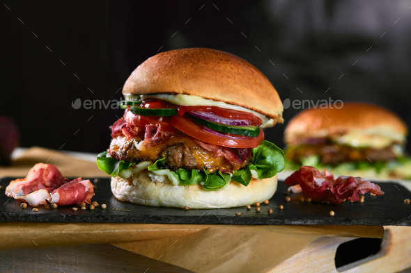 Big Sandwich - Hamburger with beef, beacon, tomato and Jalapeno sauce on dark background.