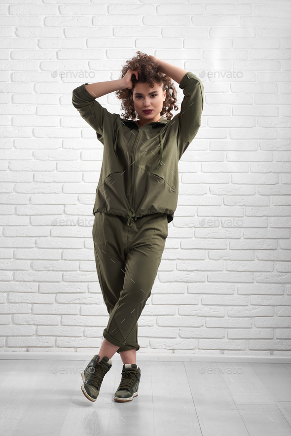 Exotic model demonstrating green modern sportsuit - Stock Photo - Images