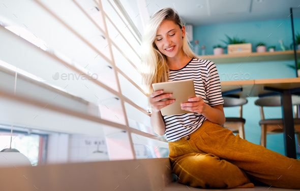 Portrait of cheerful woman using portable pc for blogging in social networks