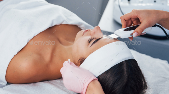 Close up view of woman that lying down in spa salon and have face cleaning procedure
