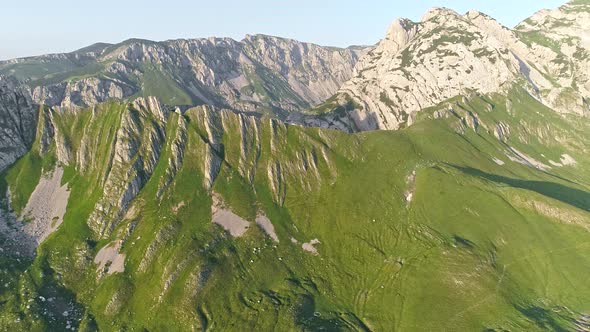 Dinarian Alps Mountains in Durmitor National Park, Montenegro. Flying Over Rocks Covered with Green alt