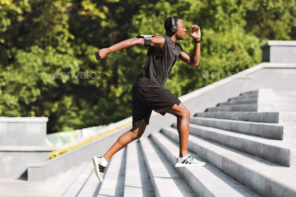 Sport Motivation. Black Male Athlete Running Up On Urban Stairs Outdoors