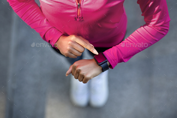 Closeup of smartwatch on sporty black girl hand