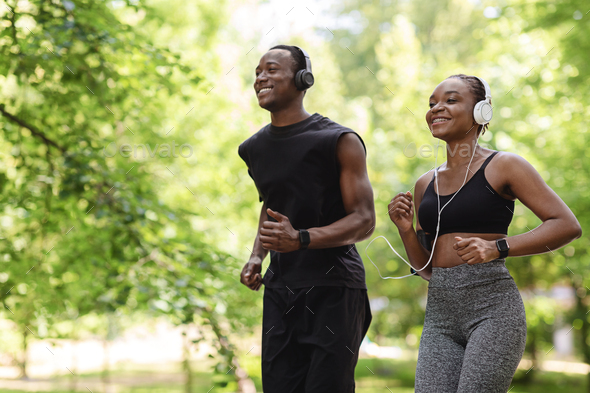 Jogging Couple. Happy Black Guy And Girl Running In Morning Park Together