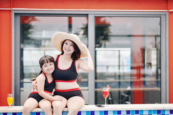 Mother and daughter in swimsuits