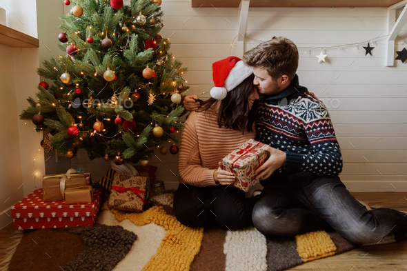 Couple exchanging Christmas gifts