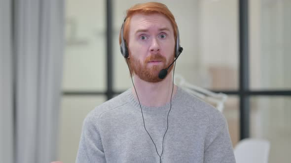 Portrait of Redhead Man Talking Through Headset with Mic  alt