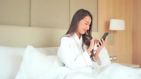 Young asian woman use smart phone alt
