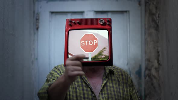 Man wearing TV in Head with a Stop Sign on the Screen. alt
