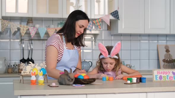 Mother with Daughter Decorates Kitchen for Easter alt
