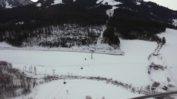 Aerial view of gondola lifts riding alt