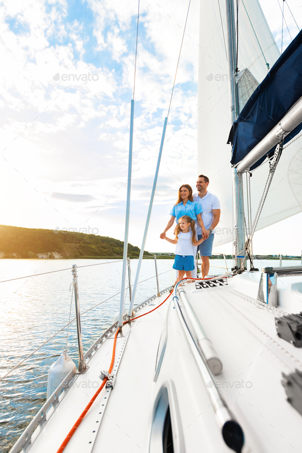 Family Sailing Relaxing During Yacht Ride Standing On Deck, Vertical