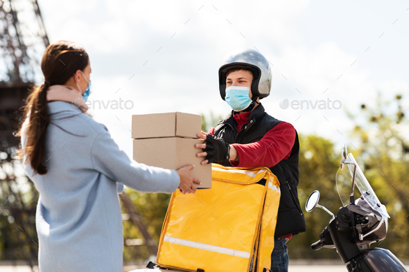 Courier Delivering Food From Cafe On Motorbike, Wearing Mask Outdoor