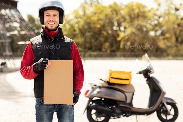 Delivery Guy Holding Paper Package Standing Near Motorbike Outdoors