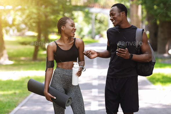 After Training Outdoors. Athletic African Couple Chatting After Working Out In Park
