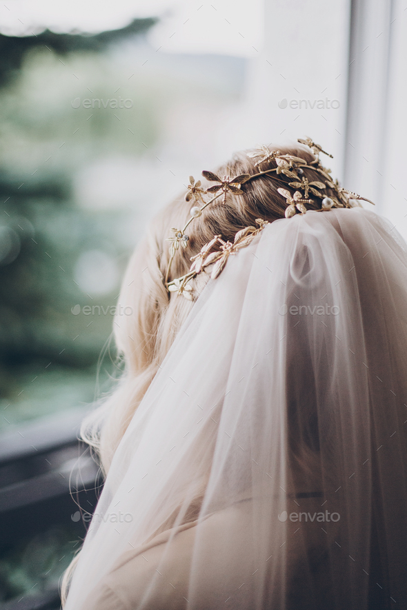 Stylish bride with golden tiara with butterflies and veil