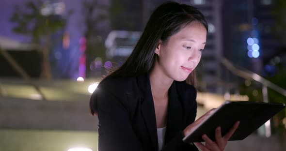 Business woman work on tablet computer at night alt