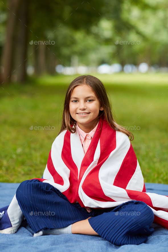 Smiling Girl Covered by USA Blanket Outdoors