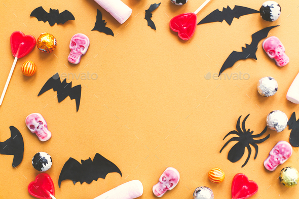 Halloween candy, skulls, black bats and ghost paper decorations