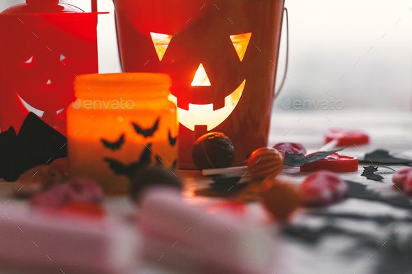 Halloween candy , jack o lantern bucket, candle and skulls