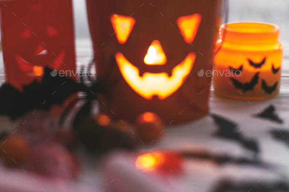 Halloween candy , jack o lantern bucket, candle and skulls