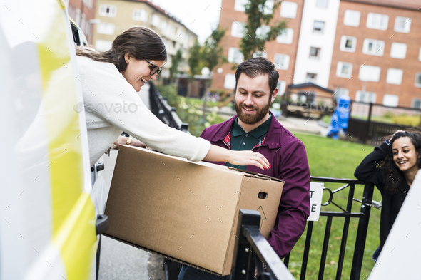 People unloading boxes from rental car - Stock Photo - Images