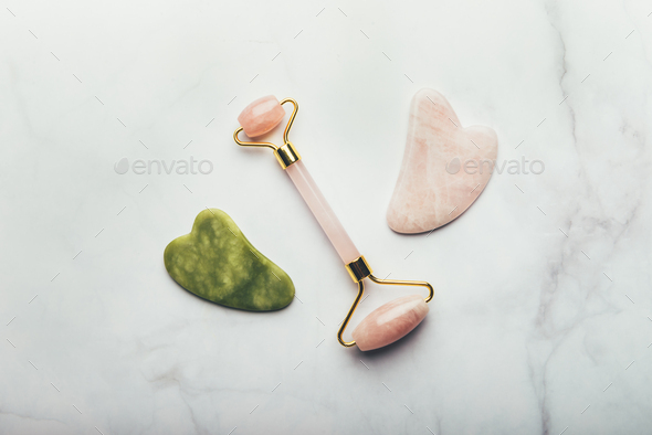 Jade face roller and Gua sha stone - Stock Photo - Images