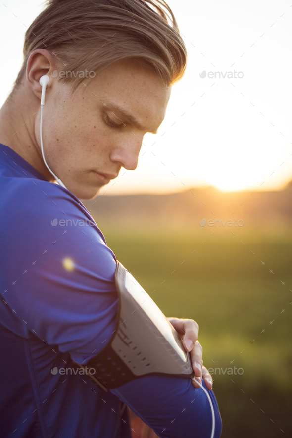 Portrait of young man checking blood pressure on wearable device