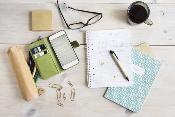 To-do-list, smart phone and office supplies on desk
