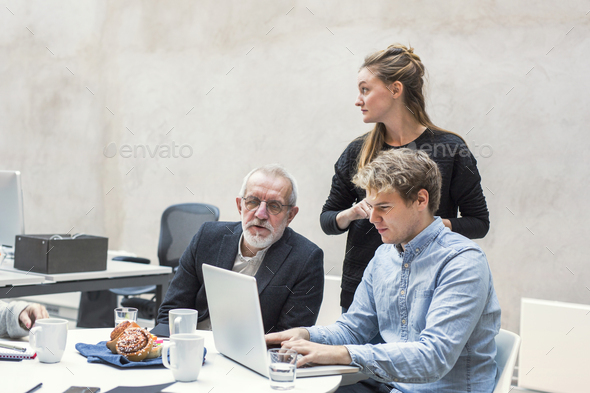 Business people preparing project on laptop in office