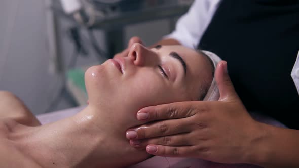 Closeup View of a Woman with Her Eyes Closed Lying on the Couch During Cosmetic Face Procedure alt