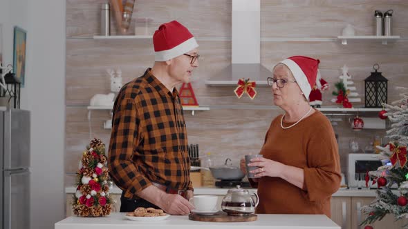 Happy Granddaughter Surprising Grandparents with Wrapper Present with Ribbon on It alt