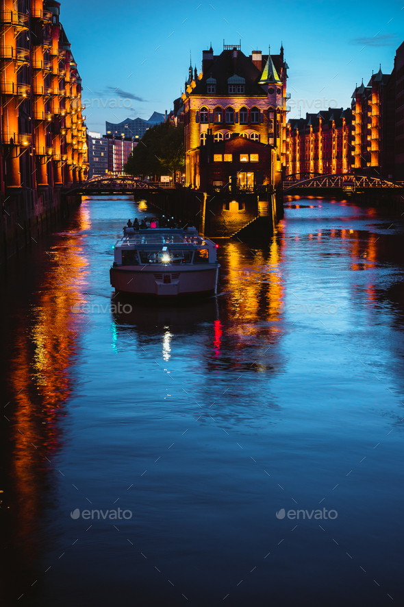 Water castle in old Speicherstadt or Warehouse district, tourist boat on a channel. Hamburg, Germany - Stock Photo - Images