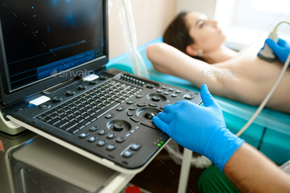 A mammologist makes breast ultrasound scanning - Stock Photo - Images