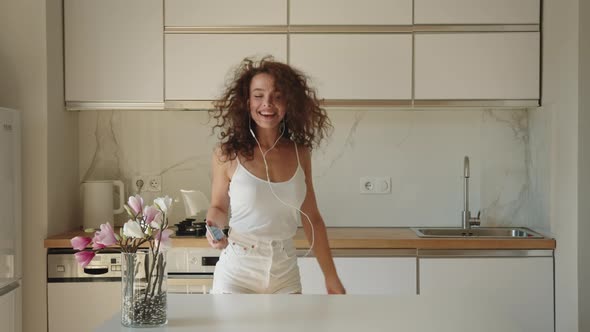 A Woman is Listening to Music with Headphones alt