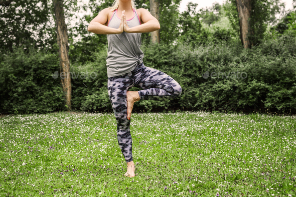 Woman practicing yoga at garden - Stock Photo - Images