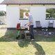 Full length of man grilling food outside house - PhotoDune Item for Sale