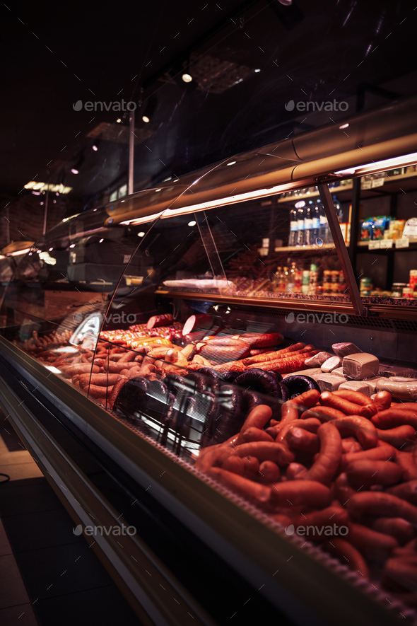 Many sausages in the butcher shop. Smoked meat assortment with huge choise. Sausage sale.