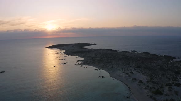 Aerial view of Elafonisi Beach at Sunrise. Flying above Sea in Greece. Golden hour above Island  alt