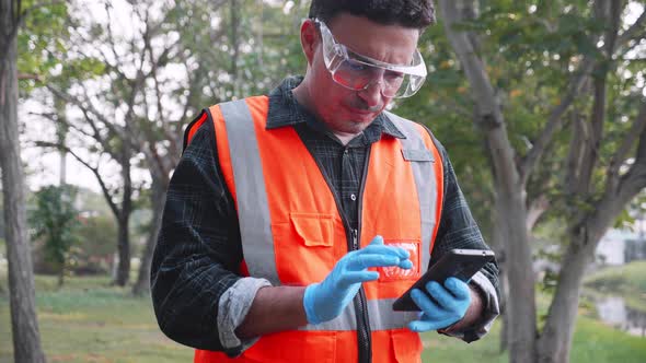 Bioengineer use smartphone doing working at site