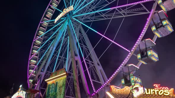 Tilt up Night Shot Of Big Lighted Ferris Wheel In Germany in funfair park alt